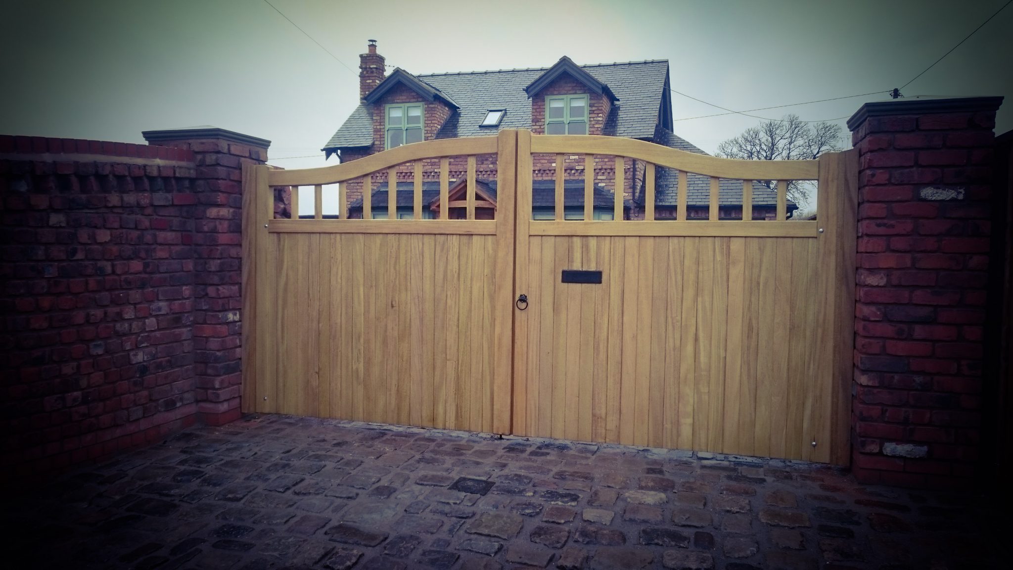 oak wooden gate with a letter box