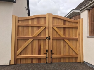 iroko hardwood swan neck driveway gates in natural state