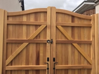 Iroko hardwood swan neck driveway gates in natural state