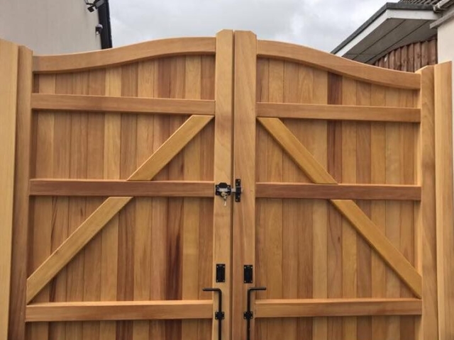 Iroko hardwood – swan neck driveway gates in natural state Iroko hardwood swan neck driveway gates in natural state